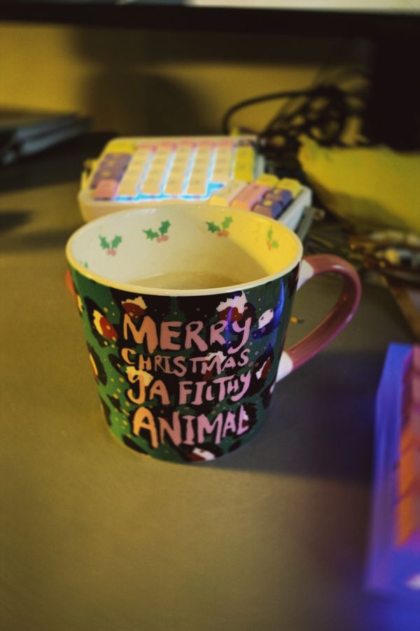 Dark green and red leopard print mug, with pink writing that says: Merry Christmas Ya Filthy Animal.
